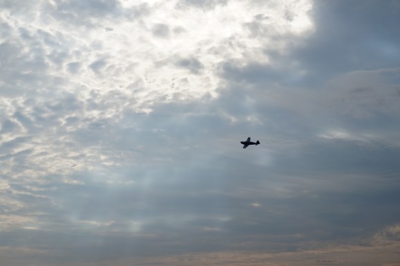 plane flying through light in the clouds